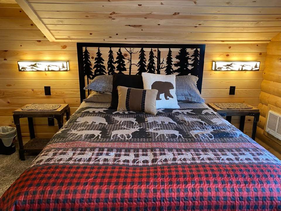 Custom metal headboard with a forest and pine tree silhouette design.